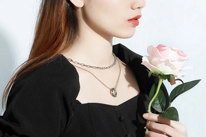 Close-up of a silver double-layer titanium steel sweater necklace with interlocking rings