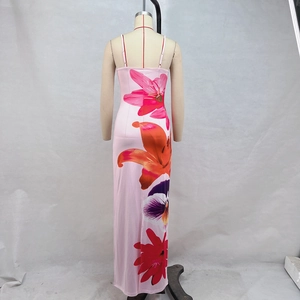Detail of pink floral print and tie-back backless design on a long summer beach dress