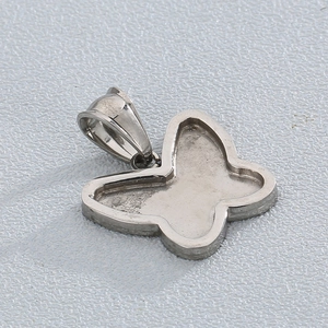 Macro detail of silver stainless steel butterfly blank pendant base for DIY jewelry making