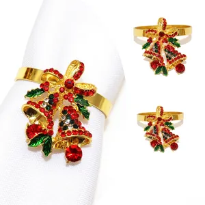 Detail of Christmas bell napkin ring with red and green rhinestones and golden finish