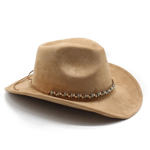 Detail of western cowboy hat crown with ethnic beaded band on khaki faux suede