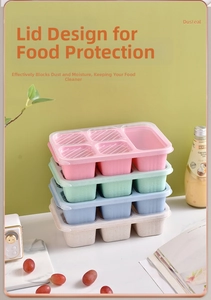 Vertical stack of four colorful six-compartment wheat straw lunch boxes with clear lids