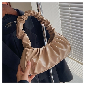 Detail of khaki pleated cloud bag showing soft PU leather texture and ruched handle