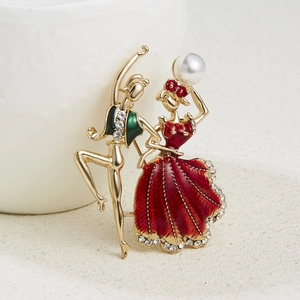 Macro shot of dancing couple brooch with red enamel dress and sparkling crystals
