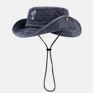 Close-up of navy washed denim bucket hat with white palm tree embroidery and chin strap