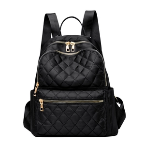 Large capacity black quilted backpack with golden zippers for travel and school use