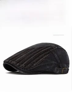 Dettaglio berretto in denim nero con cuciture decorative e fibbia in metallo regolabile