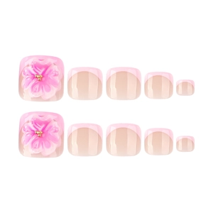 Pink press-on toenails with 3D floral accents and French tips on white background