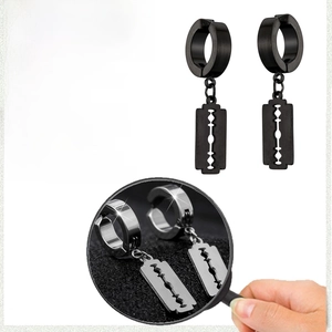 Close-up of punk style stainless steel blade pendant earrings in black and silver finishes