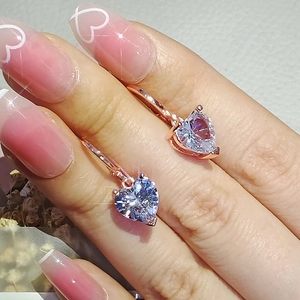 Luxury rose gold heart-shaped zircon earrings shown on a model's ear for elegant look
