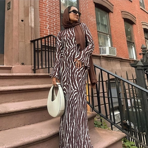 Elegant zebra print long sleeve maxi dress in dark coffee brown on a street background