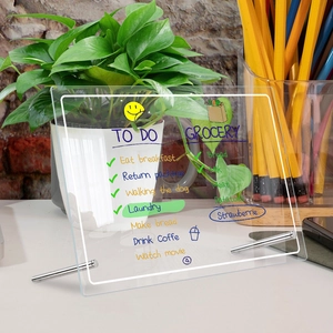Detail of LED acrylic weekly planner board with glowing edges and handwritten to-do list