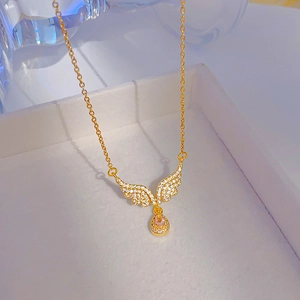 Elegant gold angel wing necklace with pink water drop zircon pendant on display