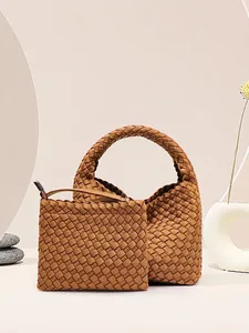 Brown woven bucket bag set with matching inner pouch and top handle in minimalist style