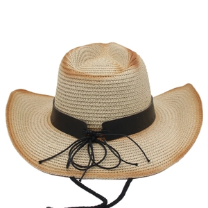 Detailed close-up of woven panama straw hat with black leather belt and curved brim