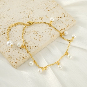 18K gold-plated stainless steel anklet featuring elegant pearl tassels on a silk background