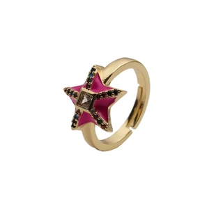 Macro shot of gold star ring with pink enamel and colorful zircon stones on band