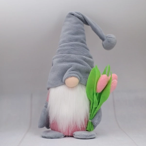 Detail of Nordic gnome plush with grey long hat and pink tulip flower decoration