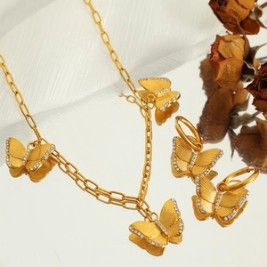 Elegant gold butterfly jewelry set with zircon crystals featuring a necklace and earrings