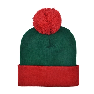 Detail of red pom-pom and green knit texture on Christmas festive beanie hat