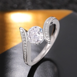 Macro shot of silver ring with split shank, pavé setting and large round center stone