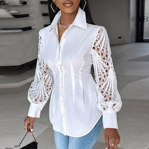 Detail of white women shirt featuring lace patchwork lantern sleeves and turn-down collar