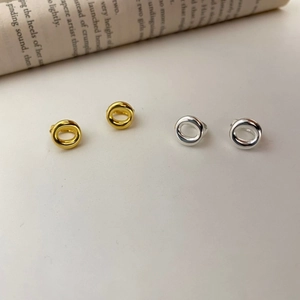 Detail shot of minimalist S925 sterling silver hoop earrings in gold and silver finishes