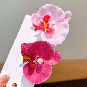 Pink and purple orchid hair clips with pearls on a 2-piece floral accessory set
