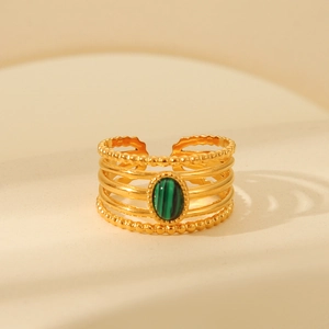 Detail of vintage gold layered steel ring with oval green malachite gemstone inlay