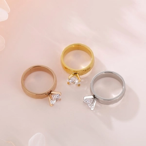 Detailed view of three minimalist 6mm rings in rose gold, gold, and silver finishes