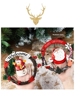 Detail of Christmas rattan wreaths with Santa and Snowman wood figures and berries