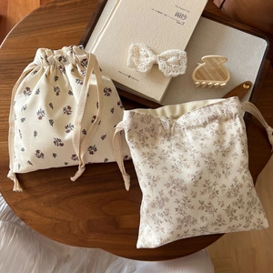 Minimalist cotton floral drawstring pouches with vintage lace hair accessories on wood