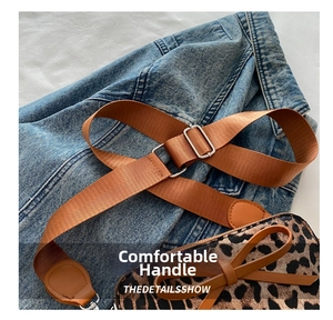 Detail showing leopard print handbag with brown nylon strap and stylish bow accent