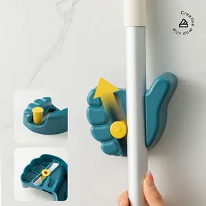 Wall-mounted thumb-shaped mop holder with secure sliding lock in blue and yellow