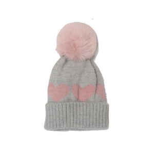 Winter knitted baby hat with pink heart pattern and a fluffy faux fur pompom on top
