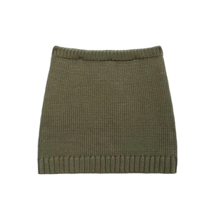 Dettaglio macro della texture della gonna in maglia verde militare e bordi a coste