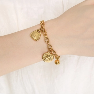 Detailed shot of 18K gold plated bracelet with heart lock and angel coin charms