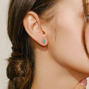 Elegant s925 silver Hamsa Hand earrings with turquoise stone shown on model's ear