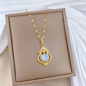 Elegant gold titanium steel necklace with drop-shaped diamond pendant on jewelry box