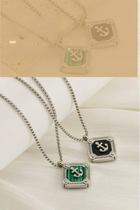 Detail of square anchor pendant with black and green stone inlays on silver chain