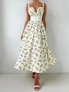 Detail of white midi dress featuring yellow lemon prints and pleats on the neckline