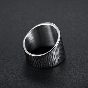 Stainless steel ring with Nordic Viking style bark texture displayed on a black background