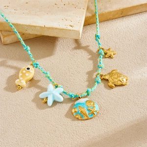 Blue woven necklace with sea life charms like starfish, sea turtle, shell and fish