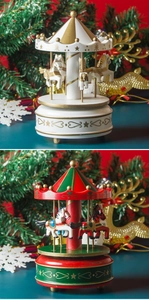 Detailed comparison of red and white Christmas carousel music boxes with gold accents