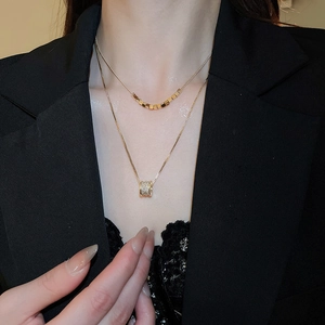 Close-up of 18k gold plated double-layer necklace with zircon pendant on a model
