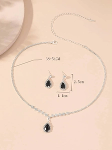 Detailed view of silver necklace and earrings set with black teardrop stones and measurements