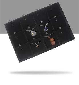 Detail of a 12-grid black velvet jewelry display tray for necklaces and pendants