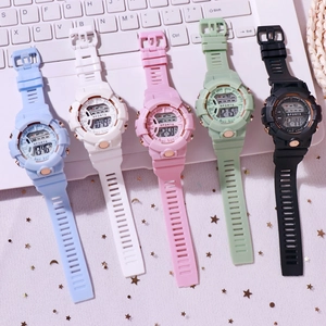 Luminous sports digital watch for kids and adults in five colors on a desktop