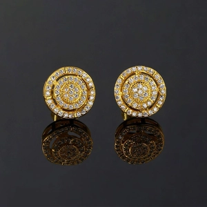 Macro shot of gold hip hop stud earrings with micro-paved white zircon on black background