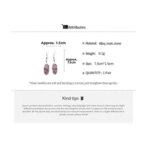 Detail view of vintage resin drop earrings showing size dimensions and material texture